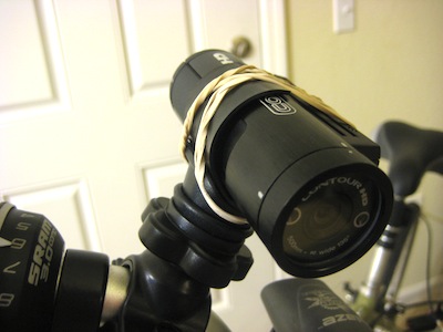 alternate view of camera on handlebar with rubber bands holding it on