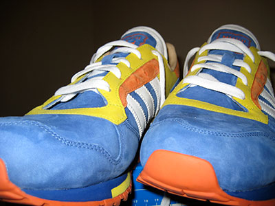 Blue, yellow, and orange sneakers with white laces