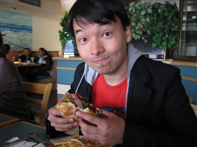 Tilek eating a burger