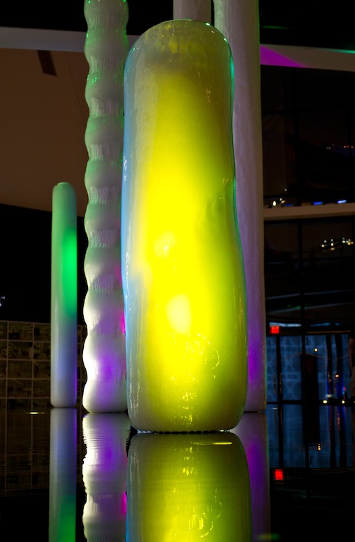 poles covered in ice with colored lights shining on them