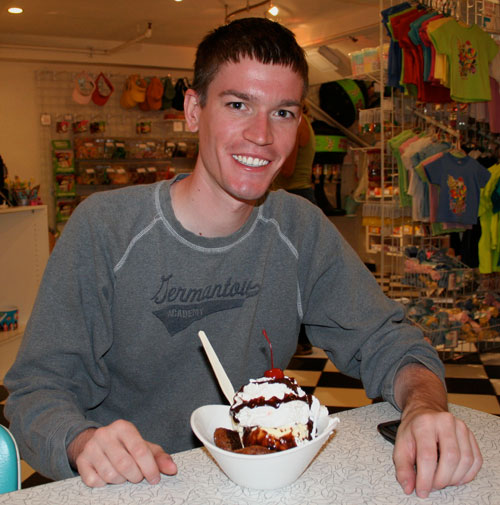 Wysz with a sundae containing two fried Oreos with vanilla ice cream, whipped cream, and a cherry on top.