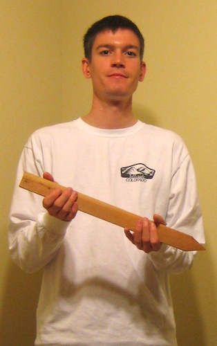 Michael Wyszomierski holding a wooden stake.