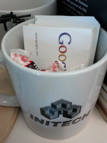 Tootsie Rolls in an Initech mug with Google business cards