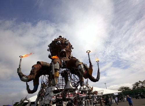 Metal octopus sculpture with fire coming out of the tips of the tentacles